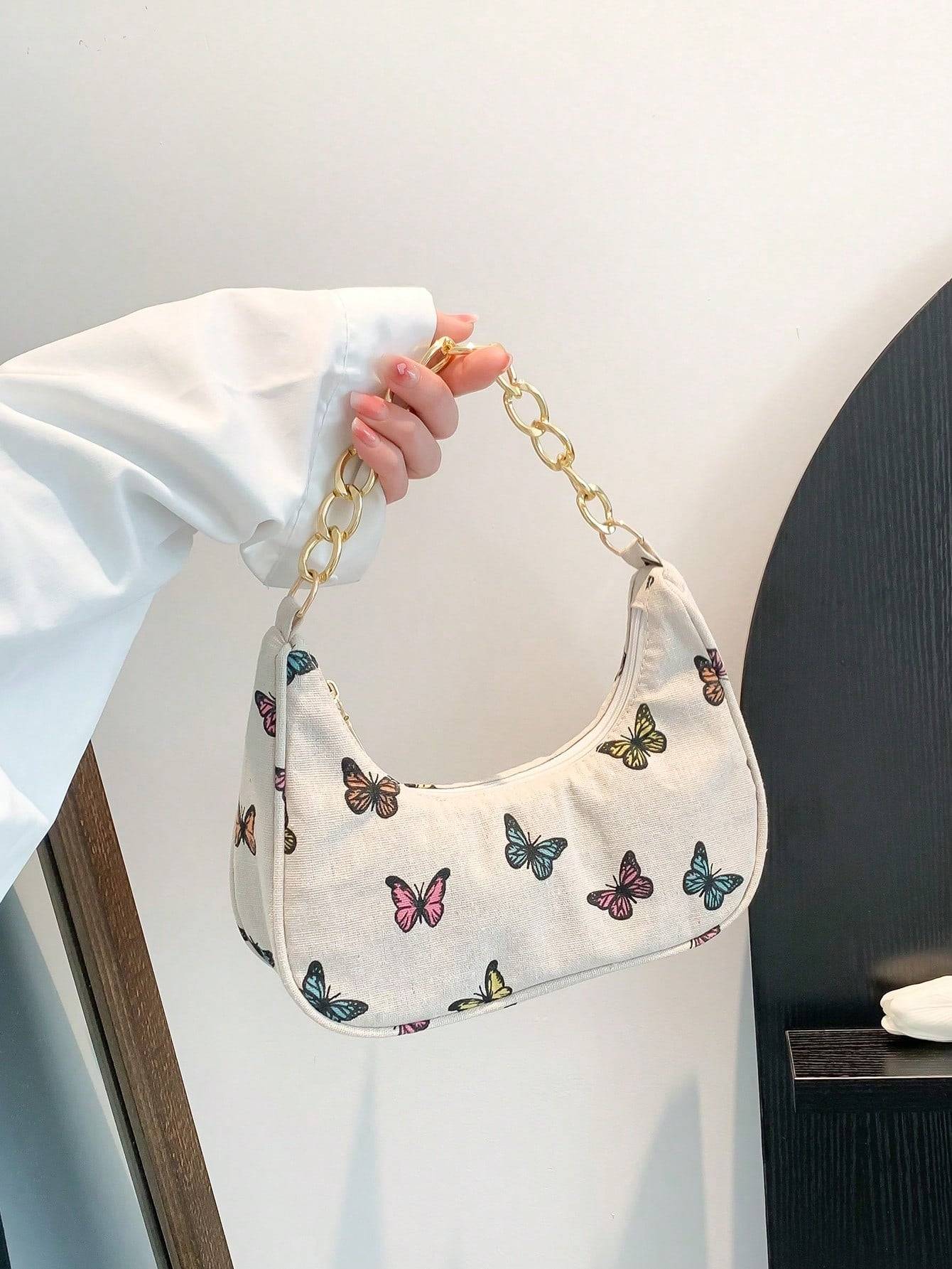 Bolso de mano con forma de media luna y flores