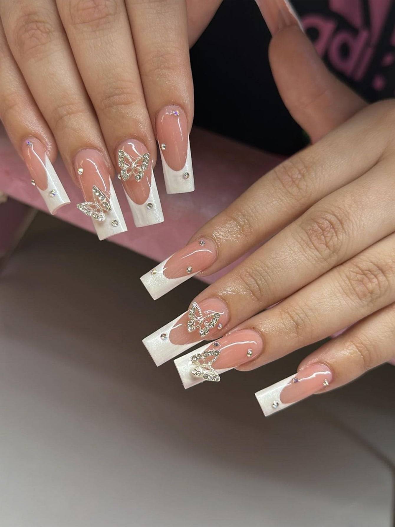 Elegant 24-Piece XL Square Press-On Nails featuring a French tip design with rhinestone butterfly accents. Perfect for a glamorous and sophisticated manicure.