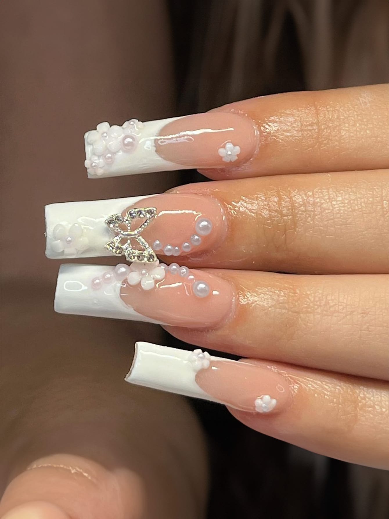 Elegant 24-piece XL square press-on nails featuring a French tip design with pearl and rhinestone embellishments for a luxurious manicure look.