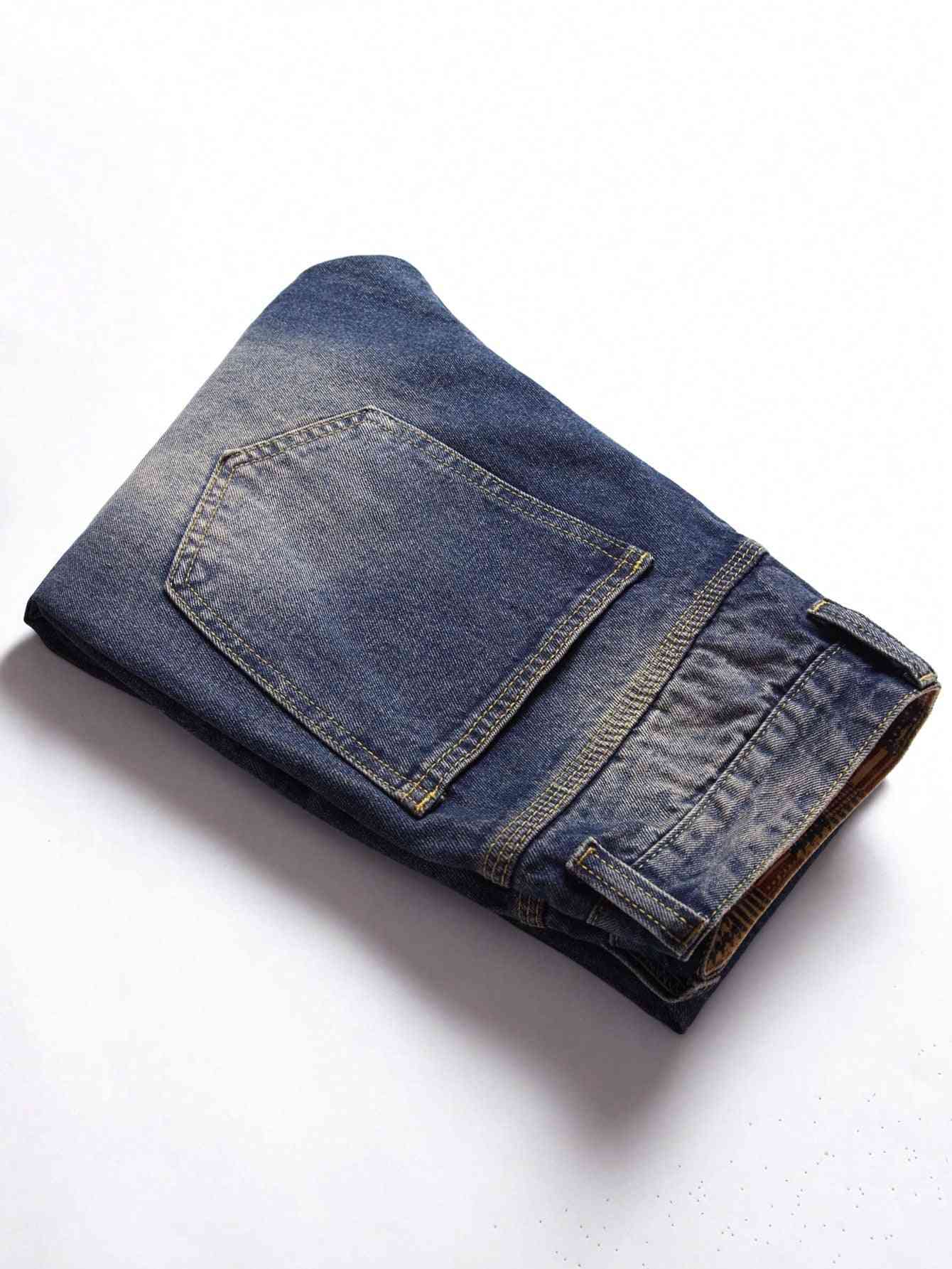 Classic blue denim jeans folded neatly, showcasing a back pocket and faded wash design. Durable and stylish, perfect for casual wear.