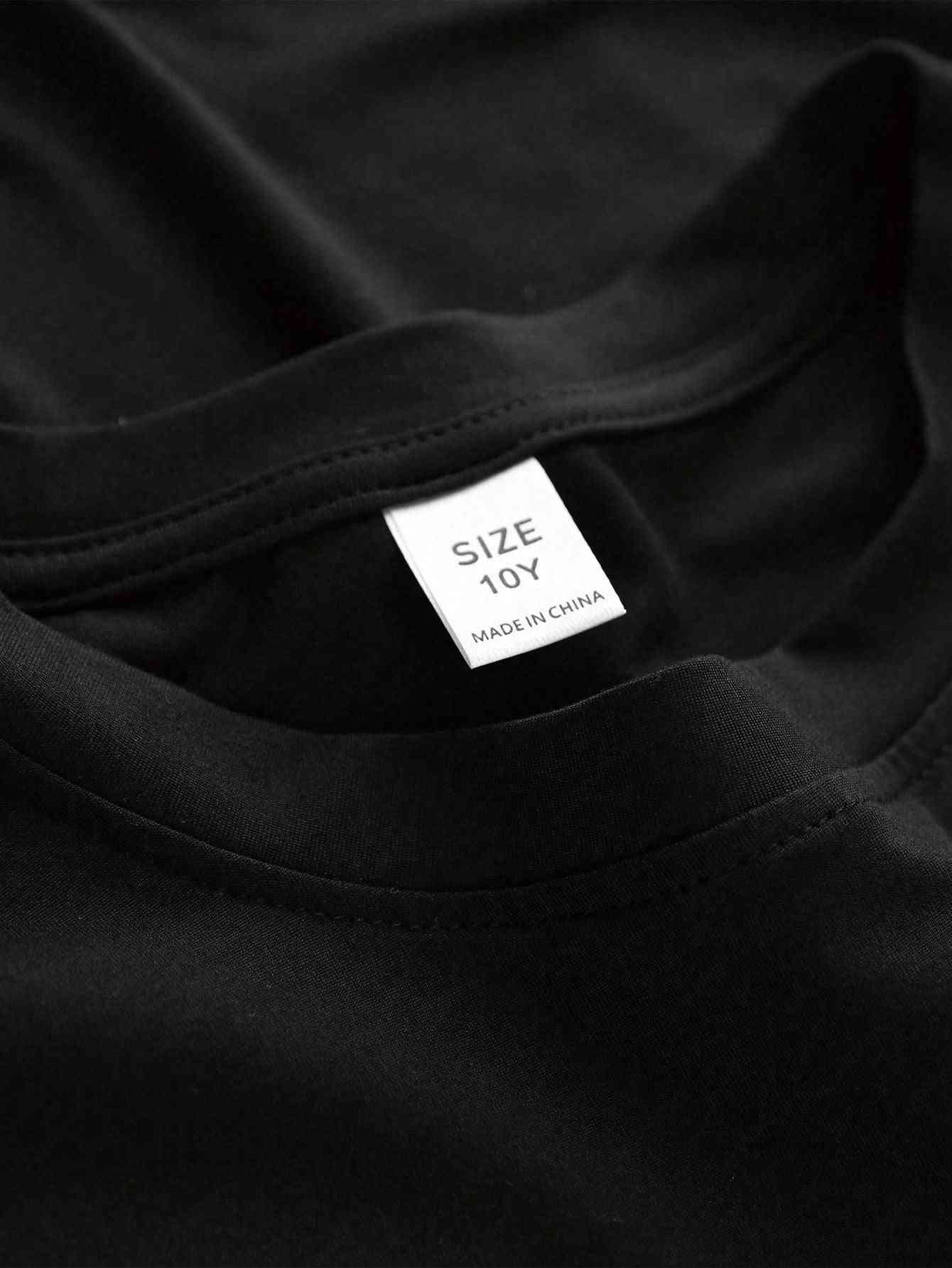 Close-up of the black t-shirt's neckline from the Cartoon 3-piece set, showing size 10Y label. High-quality stitching for durability.