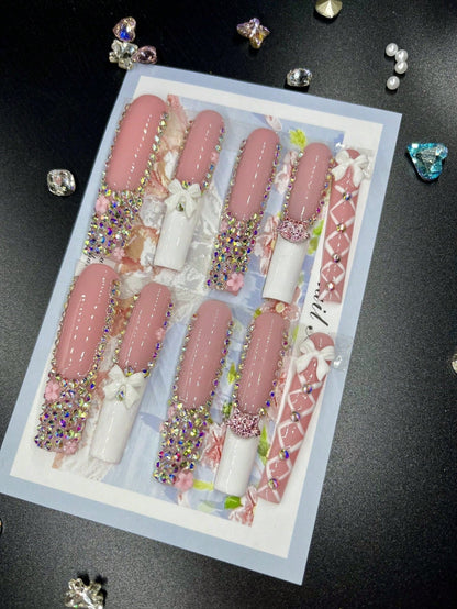 XL press-on nails with intricate designs featuring pink and white tones, 3D rhinestones, floral motifs, and bowknots for a glamorous look.