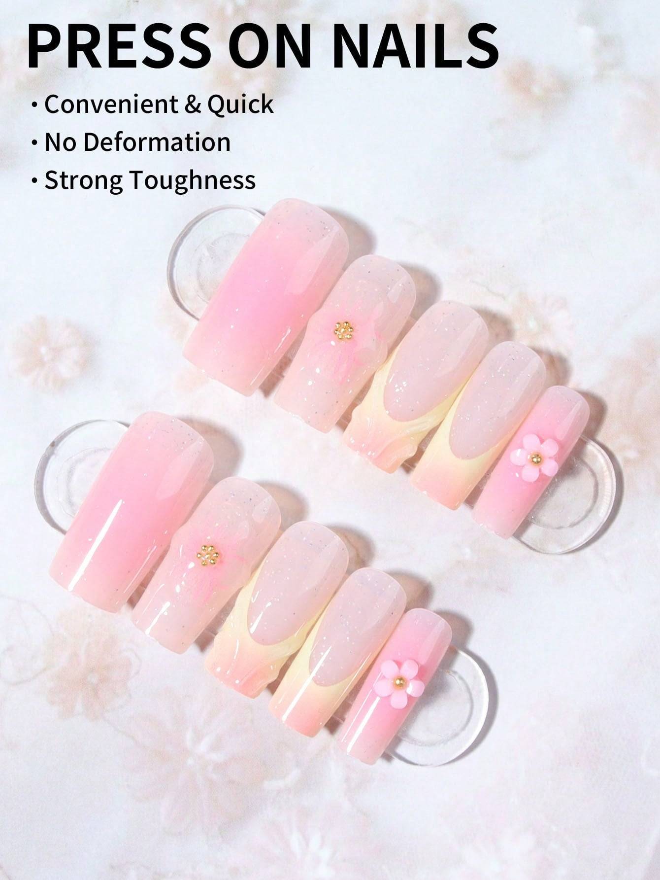 Floral French Tip Press-On Nails featuring a soft pink gradient with delicate 3D floral accents. Easy to apply, durable, and perfect for a salon-quality manicure at home.