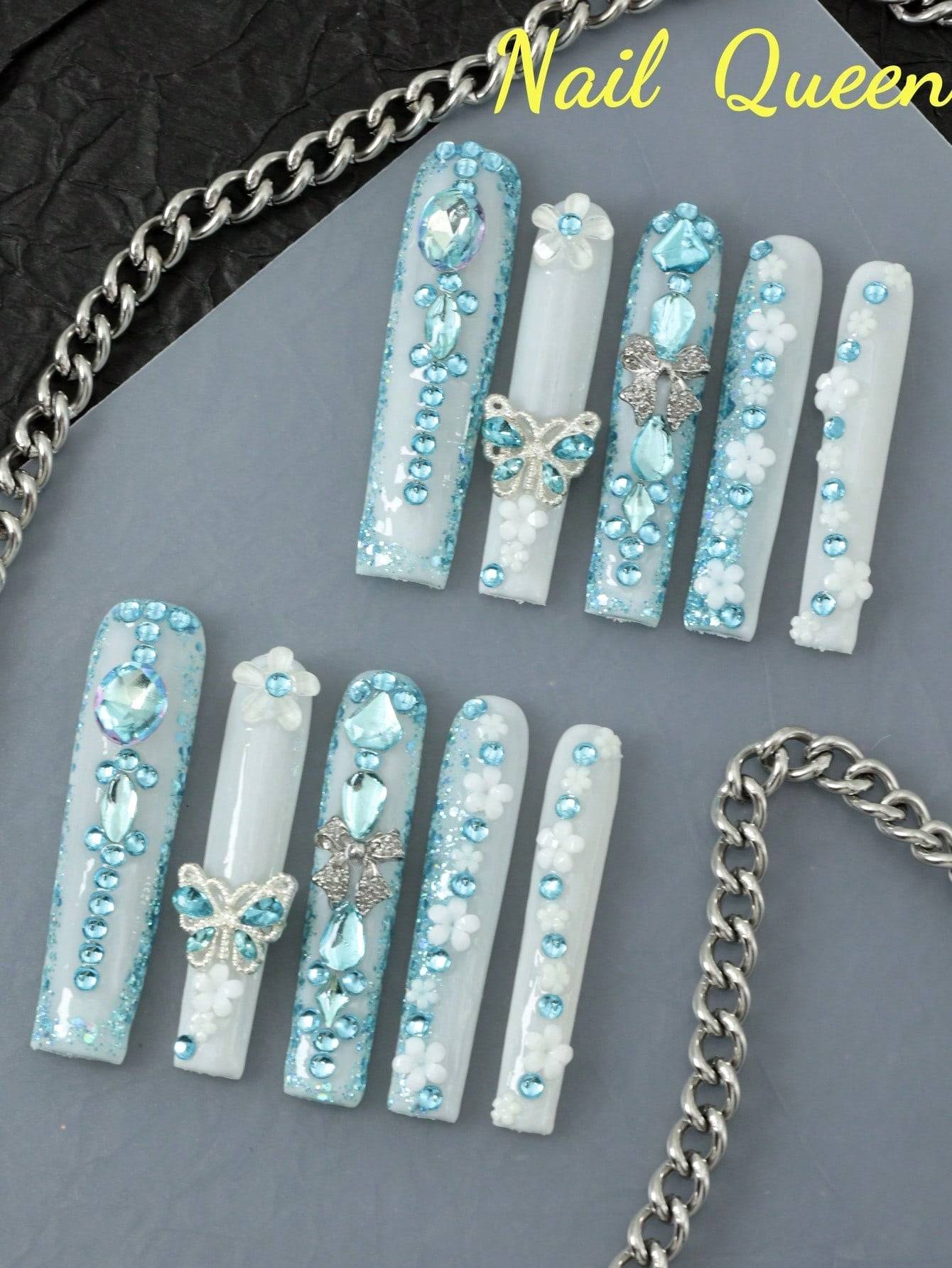 10-piece enchanting butterfly & flower press-on nails with shimmering blue rhinestones and 3D metallic butterfly accents for an elegant look.