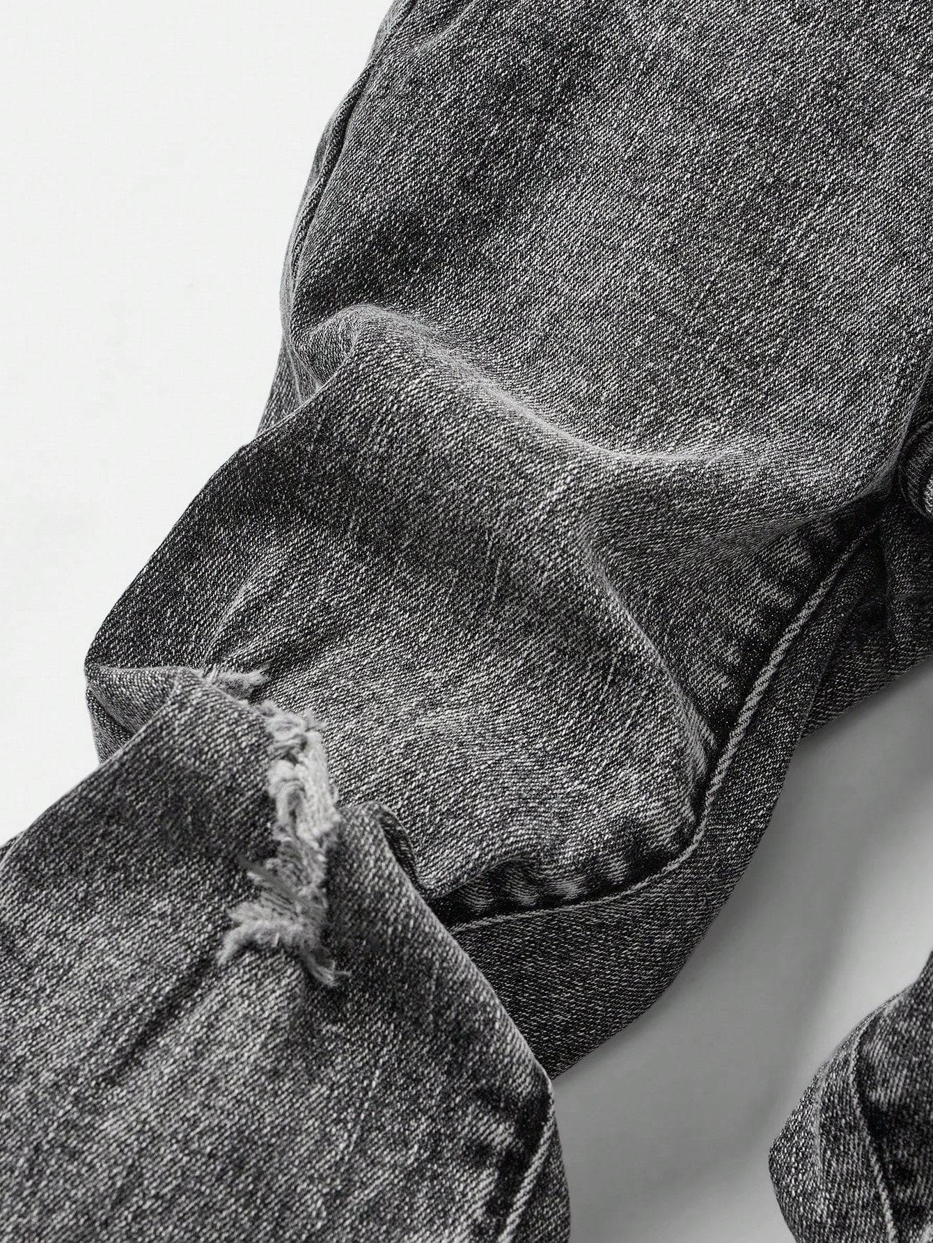 Close-up of distressed knee detail on kids' black denim jeans, adding a stylish and rugged appeal to the outfit.