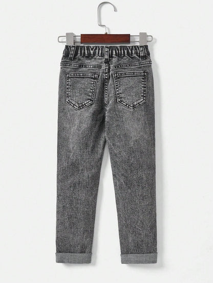 Back view of kids' black denim jeans, highlighting the classic pocket design and elastic waistband for ease of movement.