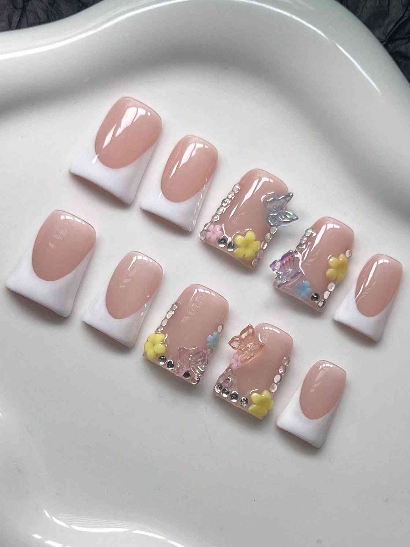 Floral and rhinestone Y2K Duck Nail Tips in a press-on style. These fake nails offer a chic nude and white design with butterfly embellishments.