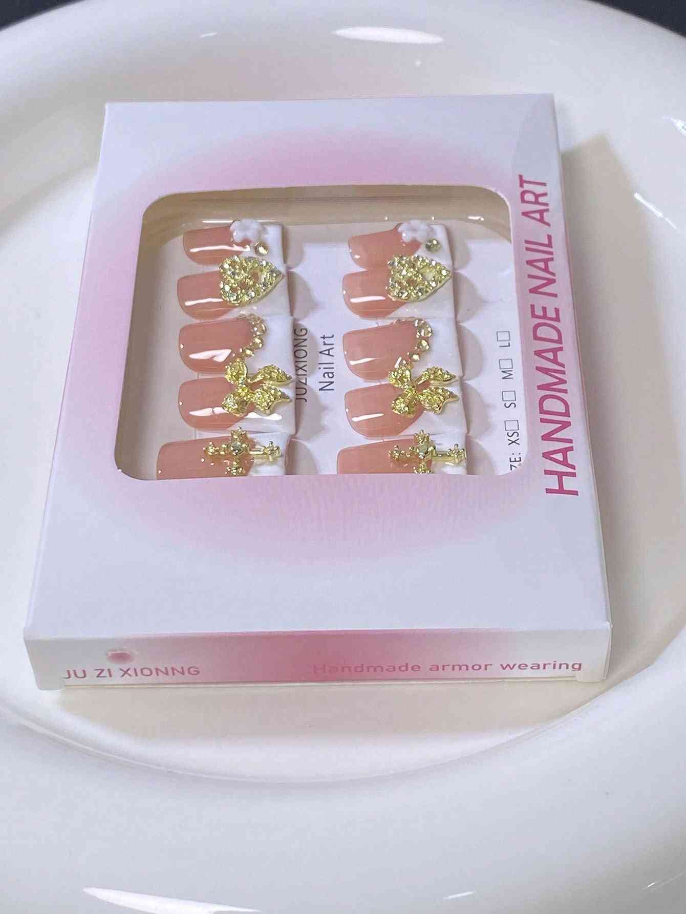 A luxury 10-piece press-on nail set inside the packaging.