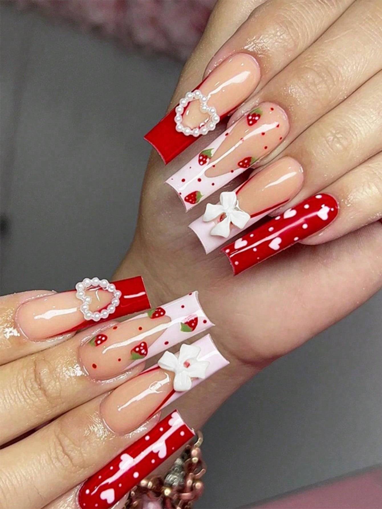 Elegant 24-Piece XL Square Press-On Nails in red and white with heart and bow embellishments. Extra-long false nails for a stylish and glamorous look.