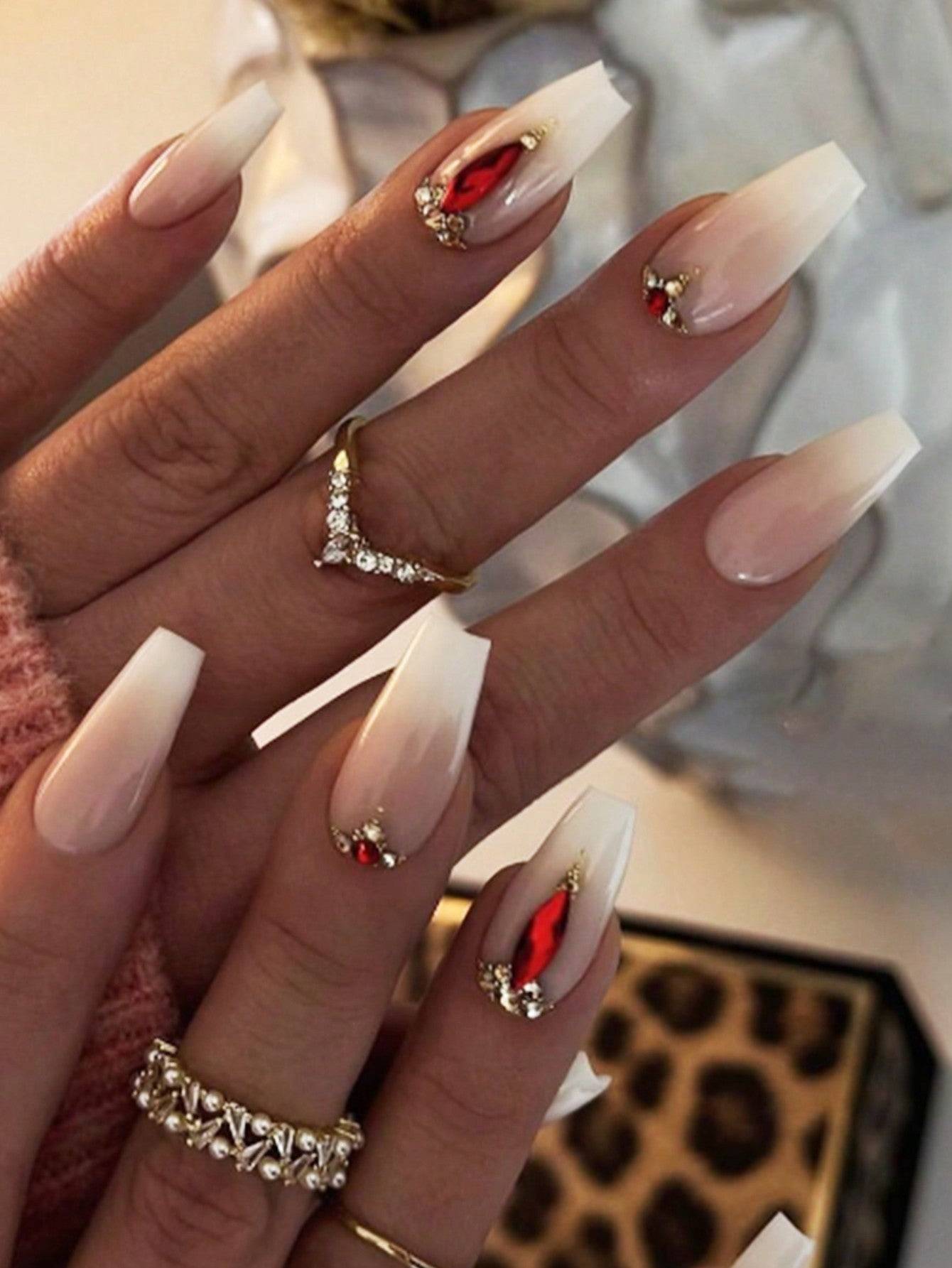 Elegant 24-piece XL square press-on nails featuring a luxurious ombre design with red gemstone accents and gold embellishments for a glamorous look.