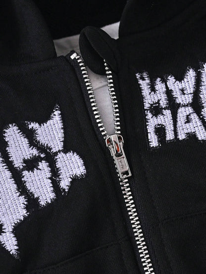 Close-up of zipper and embroidered lettering on black hoodie, showcasing durable hardware and intricate embroidery.